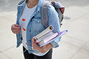 high school student holding her books