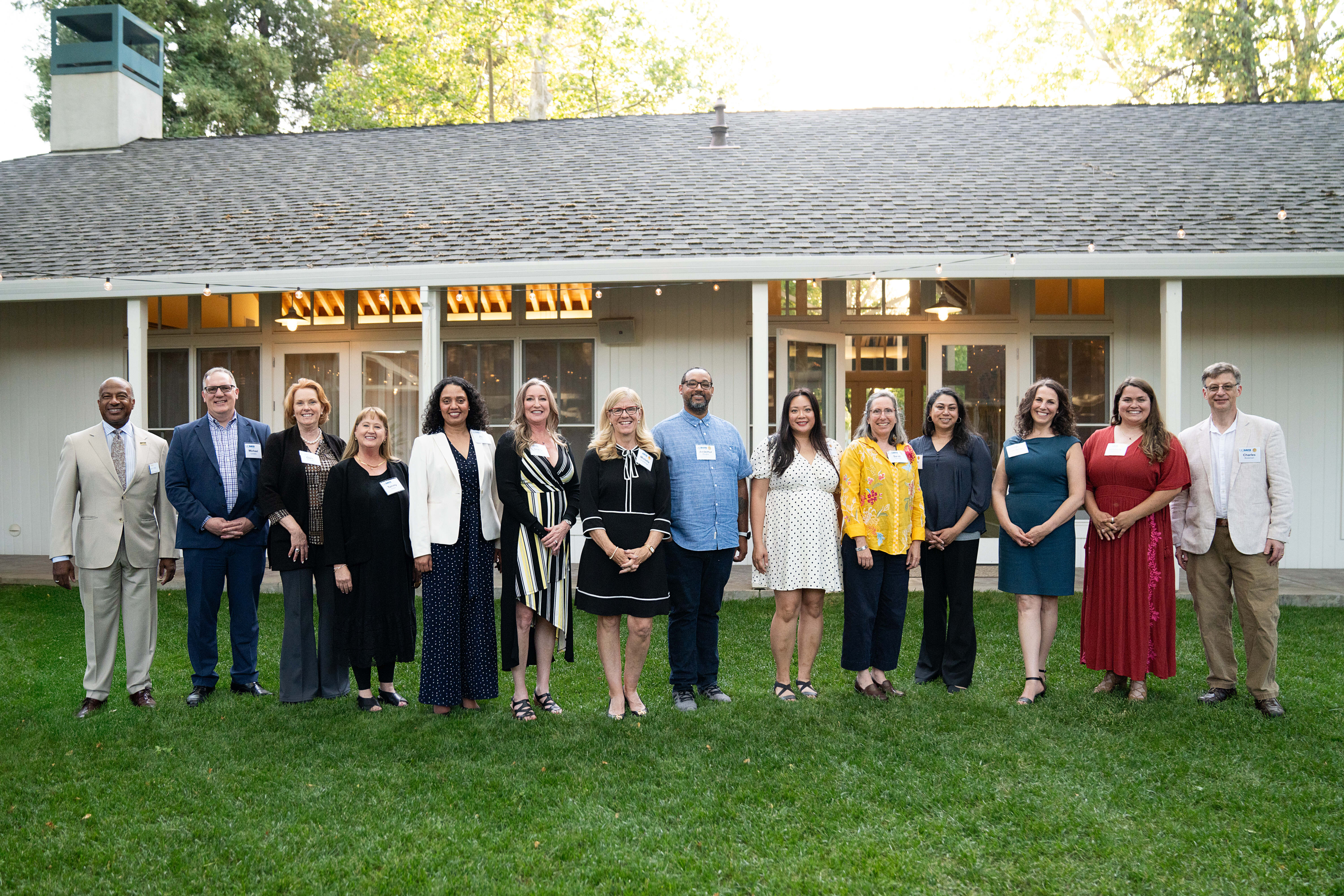 The 10 winners of the 2025 Chancellor's Outstanding Staff Award smiling alongside Chancellor May, FOA Vice Chancellor Clare Shinnerl, and CHRO Tammy Kenber at the awards ceremony.