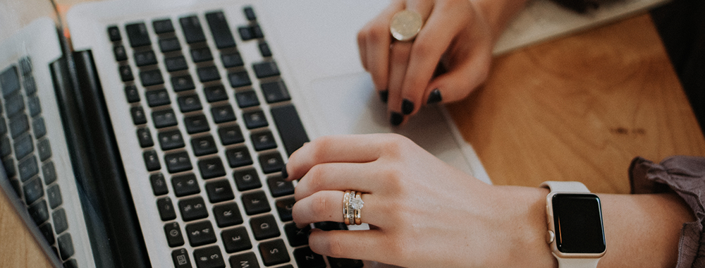 close up of hands on a laptop