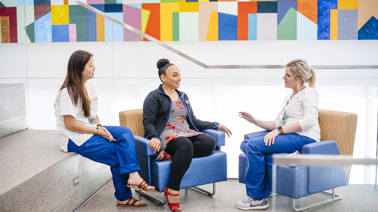 three uc davis nurses talking with one another