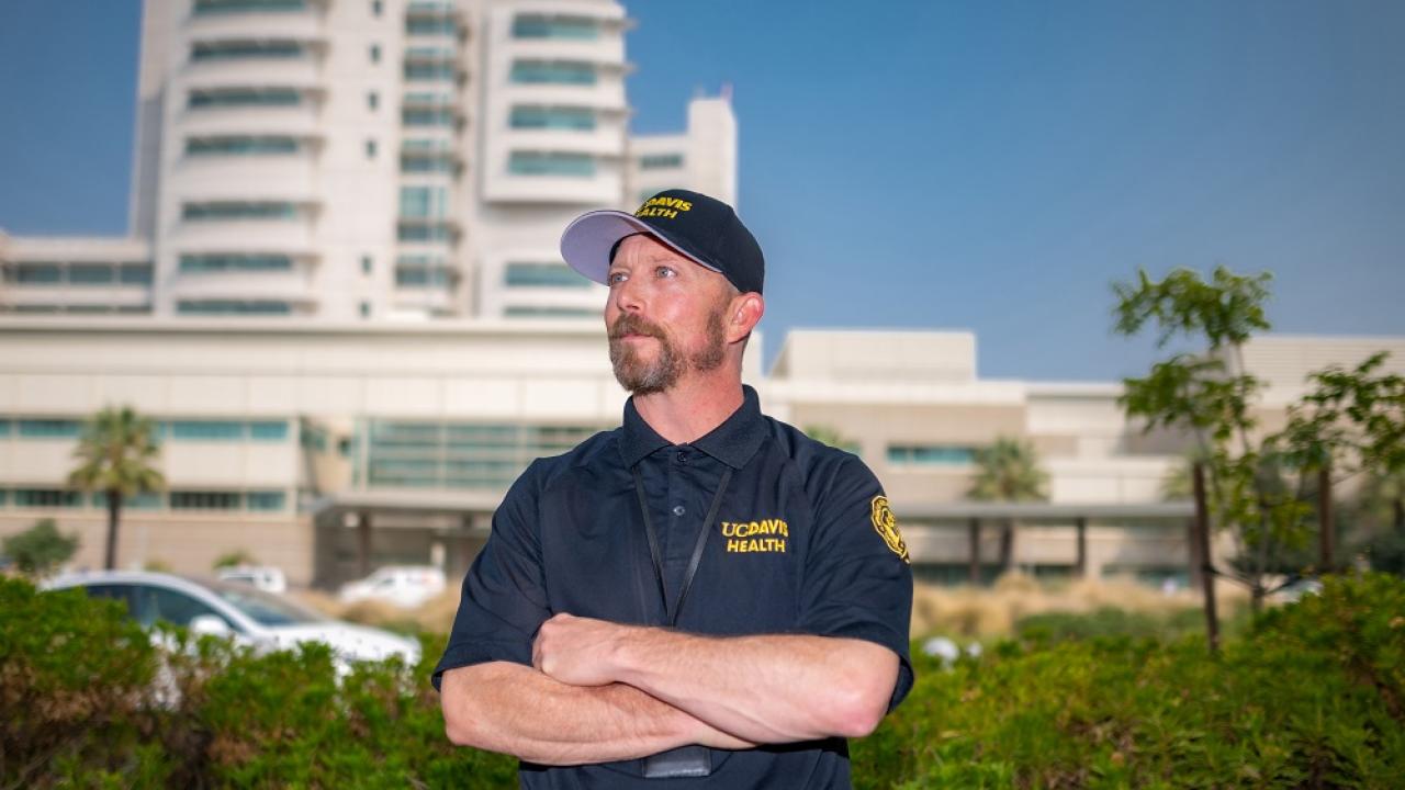 uc davis health employee with hospital in background