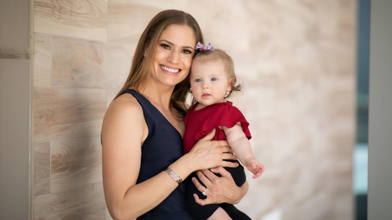 Employee Erin and baby smiling at camera