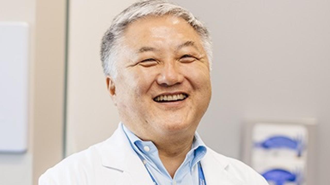 medical employee smiling at camera.