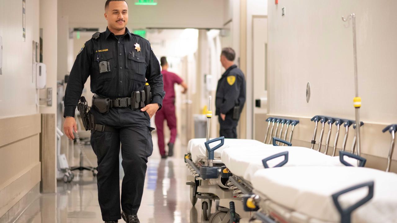Police officer walking down the hospital hallway.
