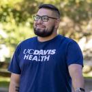 Photo of Exzavian smiling and wearing a UC Davis Health t-shirt.